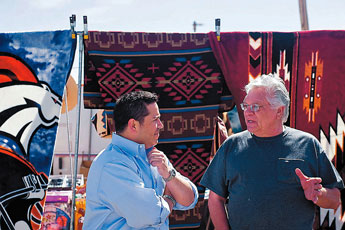 Congress Ben Ray Lujan, left, chats with vendor Tom Salaz during his visit to the Gallup Flea Market Saturday. &nbsp;&copy; 2011 Gallup Independent / Cable Hoover